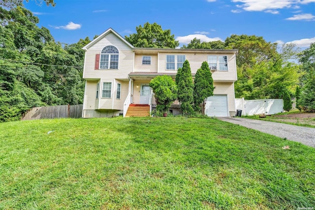 view of front of property with a front yard and a garage