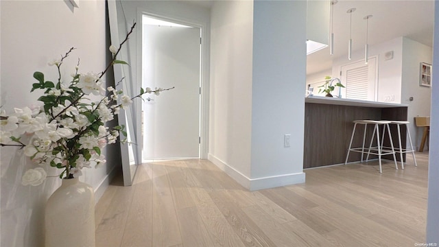 hall with hardwood / wood-style floors