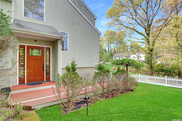 doorway to property featuring a yard