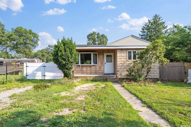 bungalow-style house with a front lawn