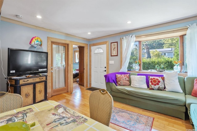 living room featuring light hardwood / wood-style flooring and ornamental molding