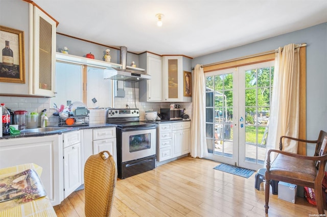 kitchen with exhaust hood, sink, electric range, light wood-type flooring, and white cabinetry