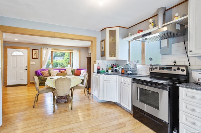 kitchen featuring island exhaust hood, light hardwood / wood-style floors, white cabinetry, and stainless steel range with electric cooktop