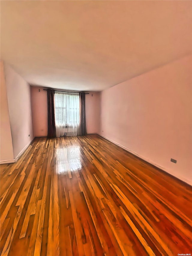 empty room with wood-type flooring