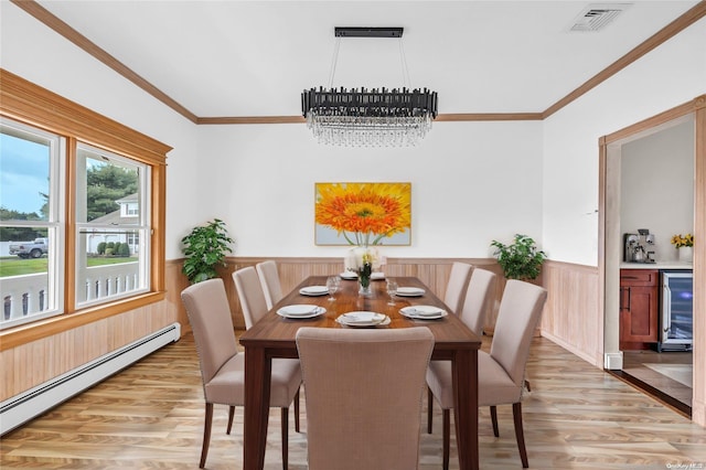 dining room with beverage cooler, baseboard heating, a notable chandelier, wood walls, and light wood-type flooring