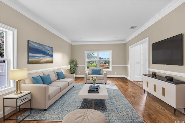 living room with crown molding and hardwood / wood-style flooring