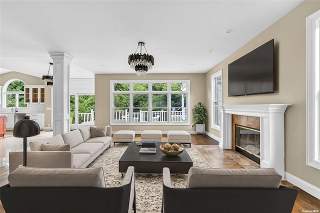 living room featuring hardwood / wood-style flooring, a notable chandelier, and sink