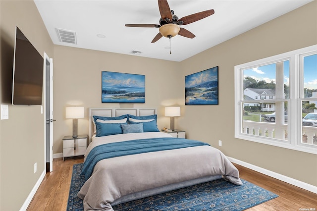 bedroom with ceiling fan and hardwood / wood-style flooring