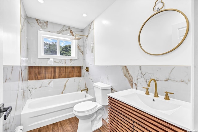 full bathroom featuring hardwood / wood-style floors, toilet, vanity, tile walls, and tiled shower / bath