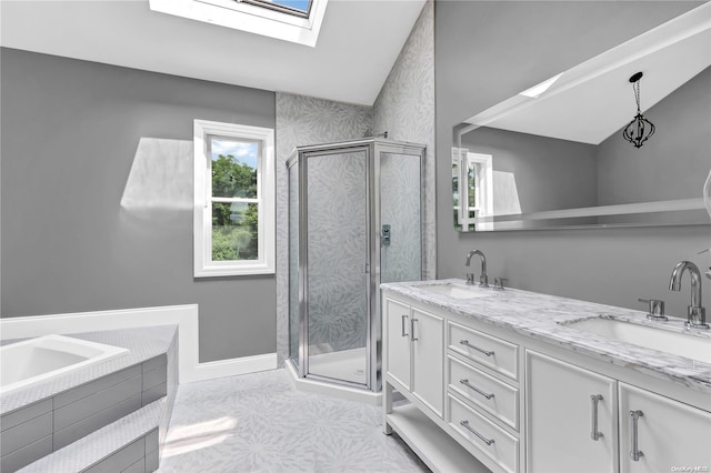 bathroom featuring vaulted ceiling with skylight, vanity, and shower with separate bathtub