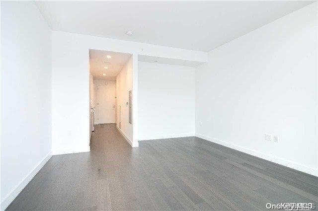 spare room featuring dark hardwood / wood-style flooring