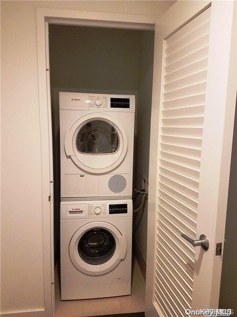 laundry area with stacked washer and dryer