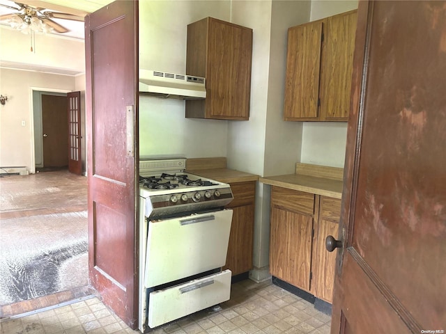 kitchen with ceiling fan, white gas stove, range hood, and a baseboard heating unit