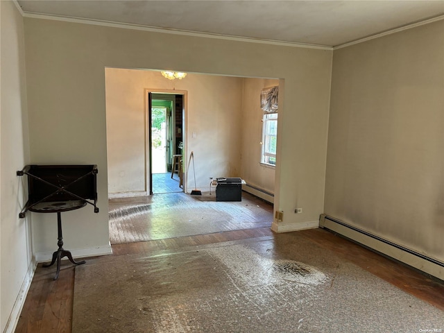 empty room with crown molding, plenty of natural light, wood-type flooring, and a baseboard heating unit