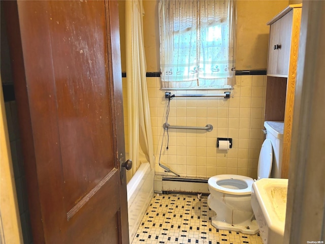 bathroom featuring tile patterned flooring, a baseboard heating unit, toilet, shower / bath combo with shower curtain, and tile walls