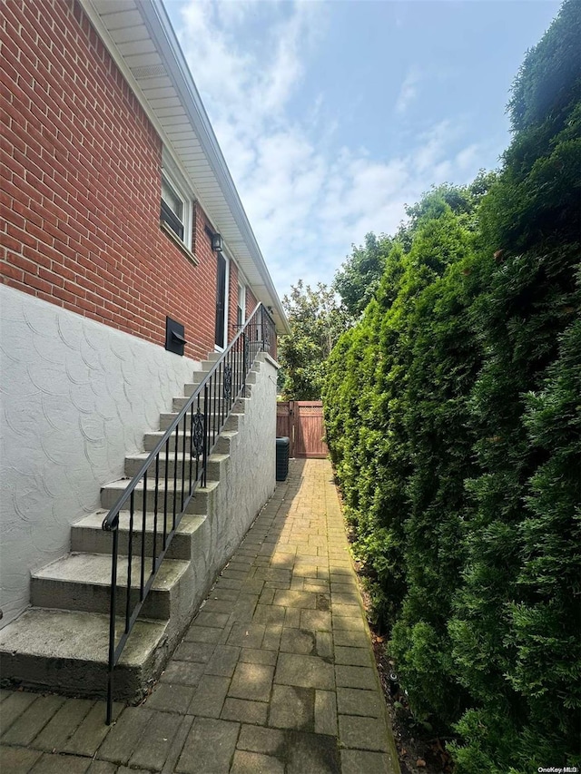 view of side of home with central air condition unit