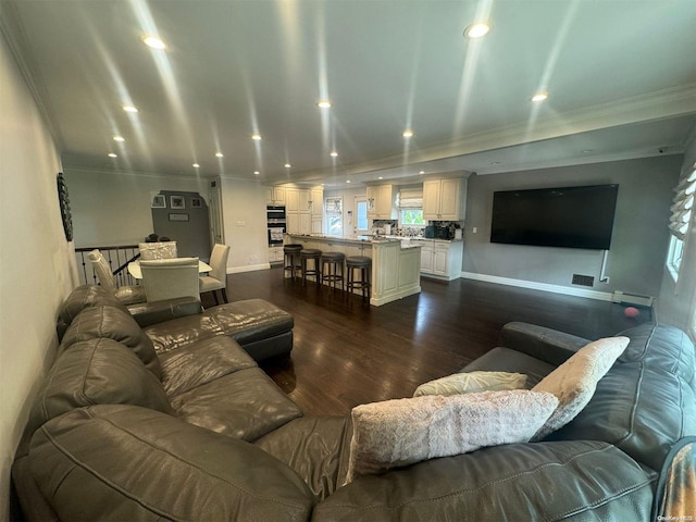 living room with dark hardwood / wood-style flooring and crown molding