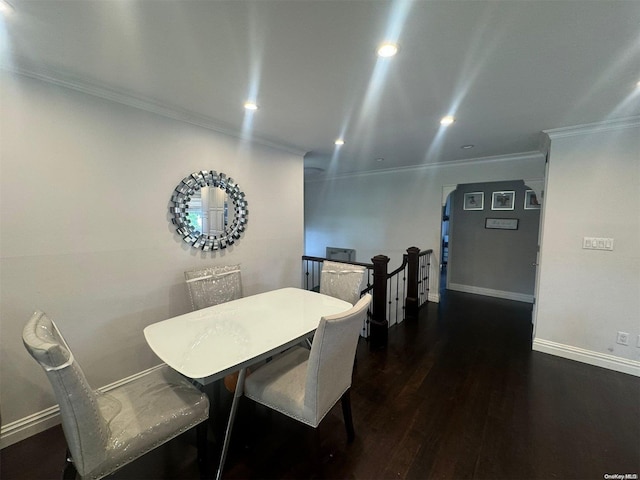 dining space featuring dark hardwood / wood-style floors and crown molding