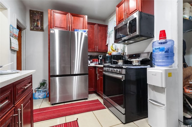 kitchen with light tile patterned floors and stainless steel appliances