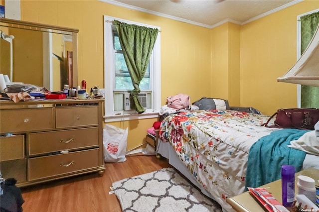 bedroom featuring light hardwood / wood-style floors and crown molding