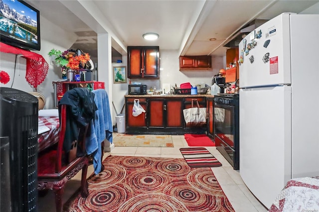 kitchen featuring light tile patterned flooring and black appliances