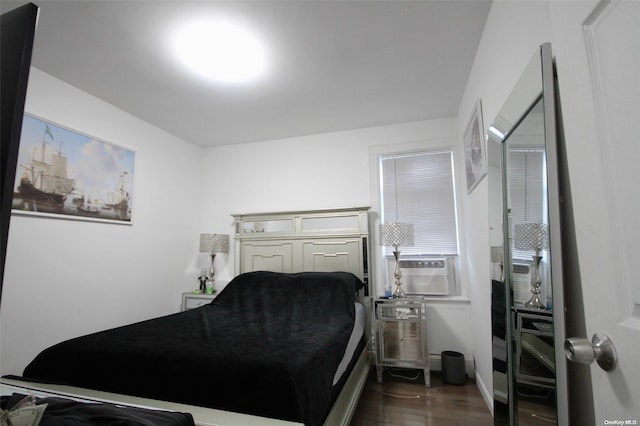 bedroom with dark hardwood / wood-style flooring and cooling unit