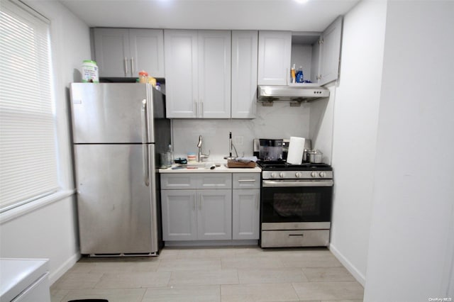 kitchen with gray cabinets, sink, appliances with stainless steel finishes, and tasteful backsplash