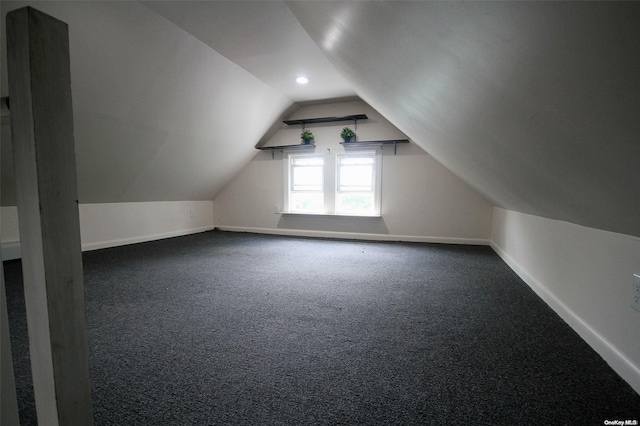 additional living space featuring carpet flooring and lofted ceiling