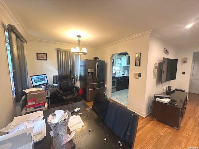 interior space featuring a notable chandelier, light hardwood / wood-style floors, and crown molding