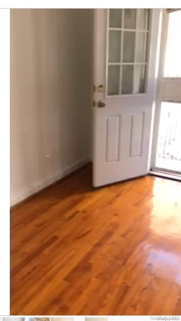 unfurnished room featuring hardwood / wood-style flooring