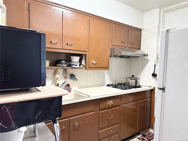 kitchen featuring white appliances and sink