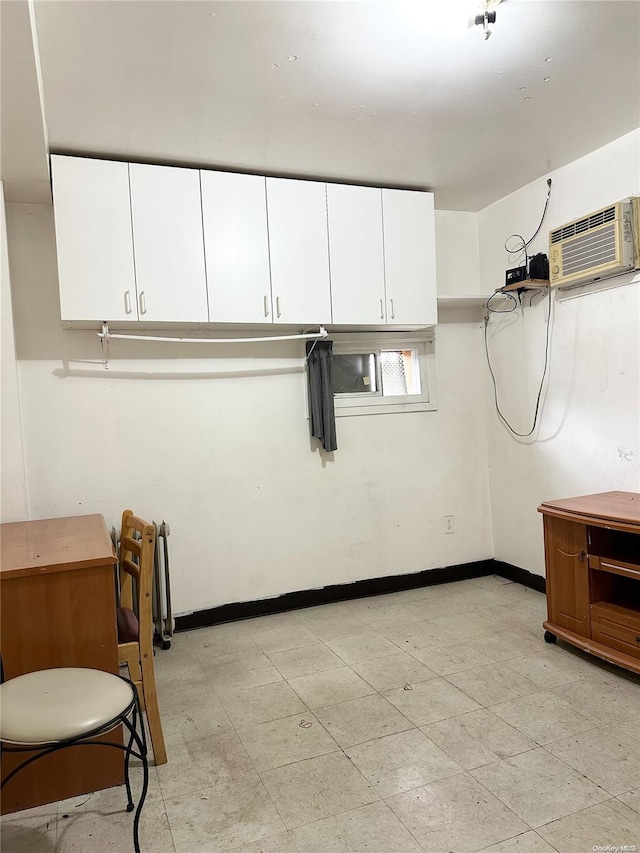 laundry room with an AC wall unit