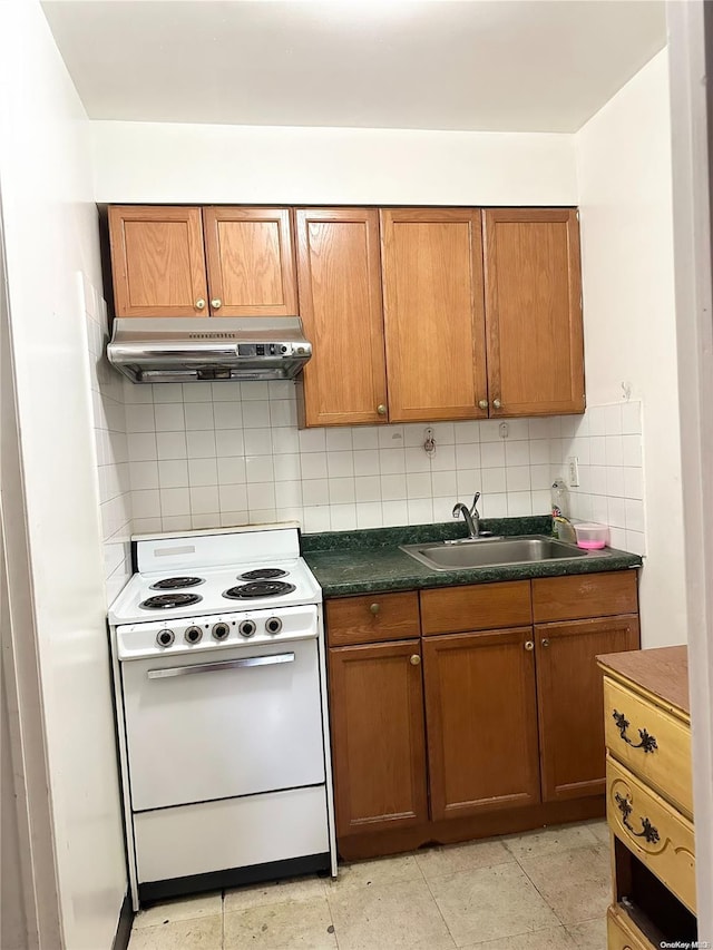 kitchen featuring decorative backsplash, electric range oven, and sink