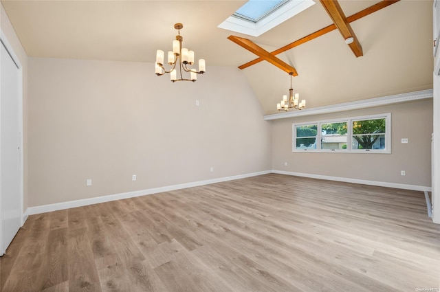 interior space with a skylight, light hardwood / wood-style flooring, high vaulted ceiling, and a chandelier