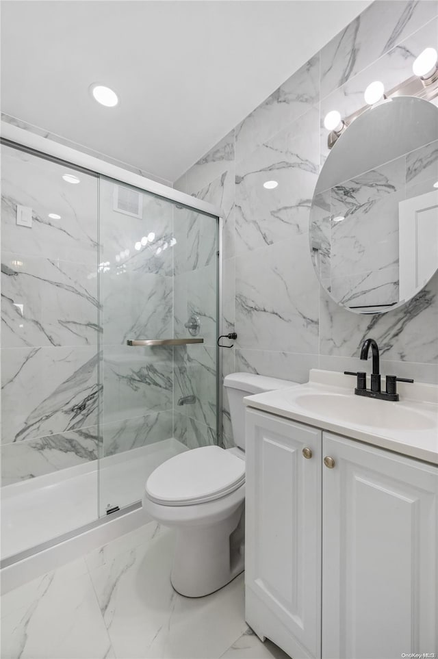 bathroom featuring an enclosed shower, vanity, toilet, and tile walls