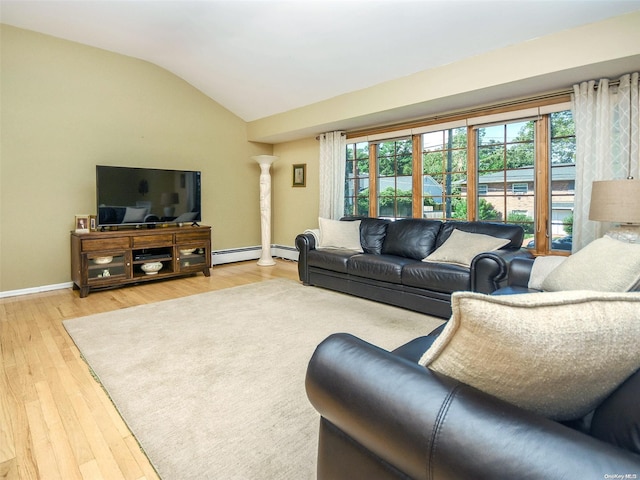 living room with light hardwood / wood-style floors, vaulted ceiling, decorative columns, and a baseboard heating unit