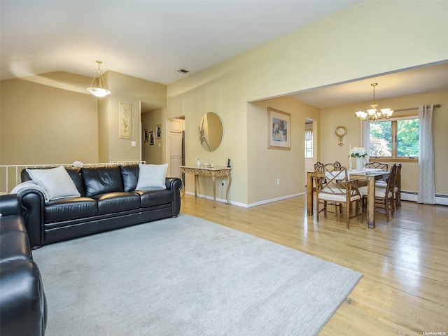 living room featuring a chandelier and light wood-type flooring