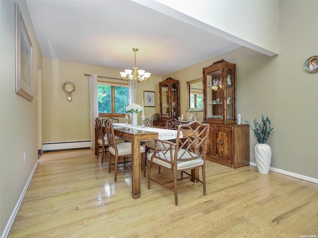 dining space with a chandelier, light hardwood / wood-style floors, and a baseboard radiator