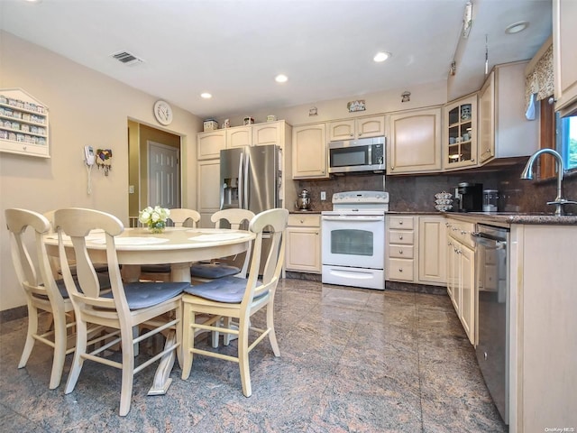 kitchen with sink, backsplash, and appliances with stainless steel finishes