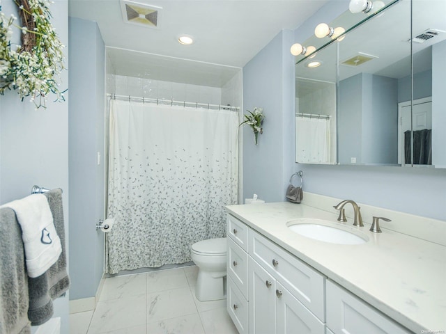 bathroom with vanity, toilet, and walk in shower