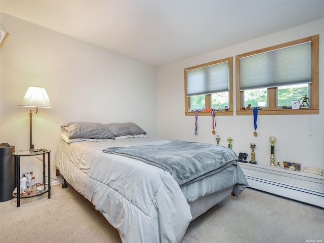 carpeted bedroom with a baseboard radiator