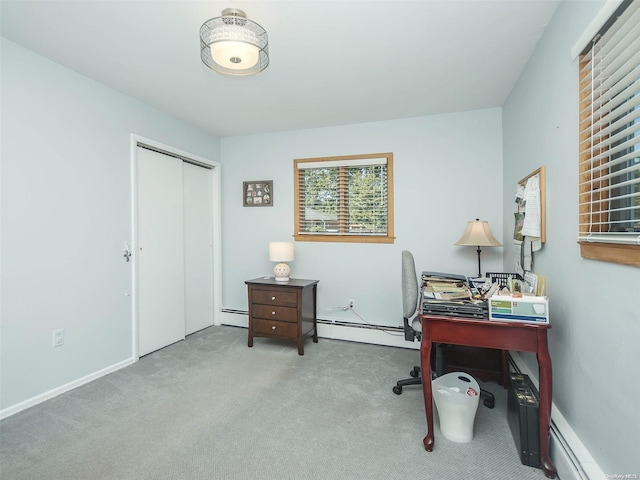 carpeted home office featuring a baseboard heating unit