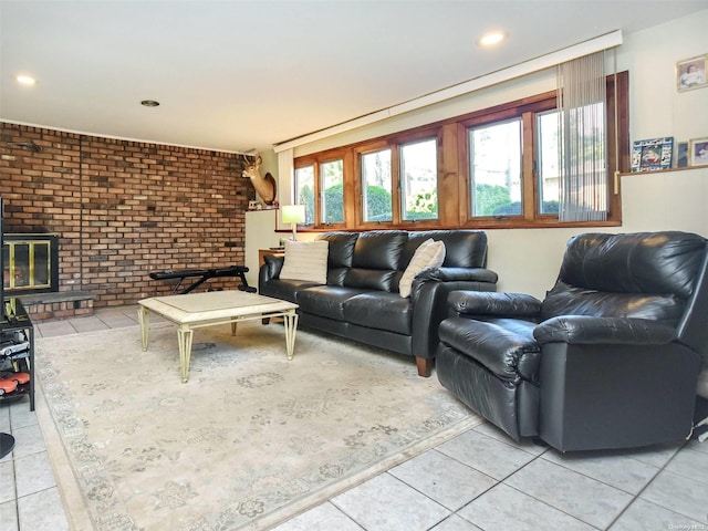 living room with tile patterned flooring, a fireplace, and brick wall