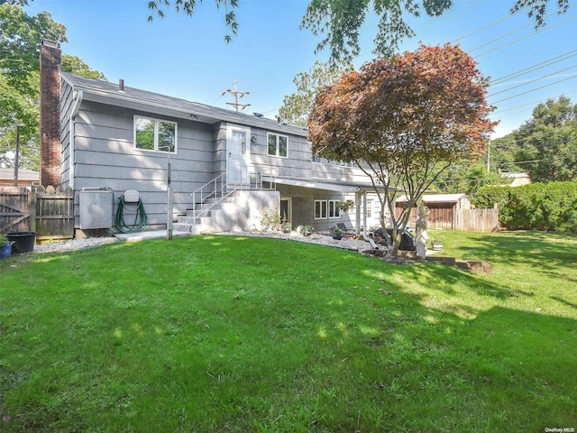 rear view of property with a lawn