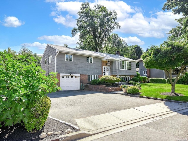 split foyer home with a garage and a front lawn