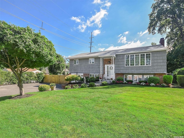 bi-level home with a front lawn