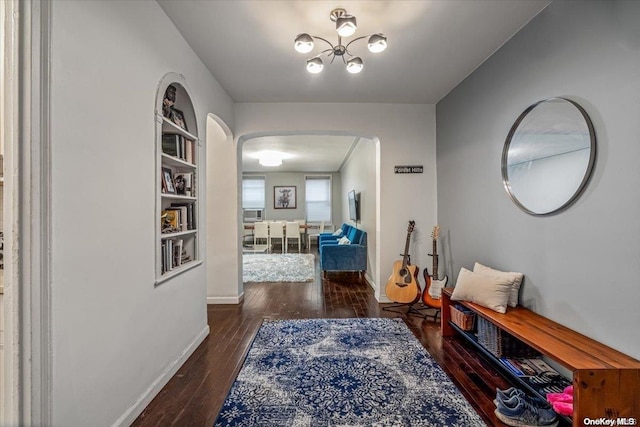 corridor with dark hardwood / wood-style flooring