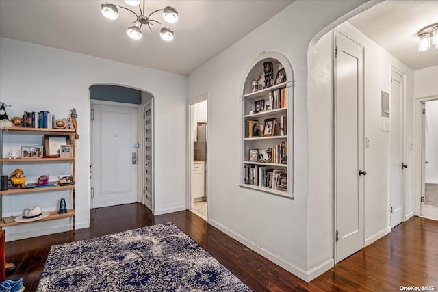 corridor with dark hardwood / wood-style flooring