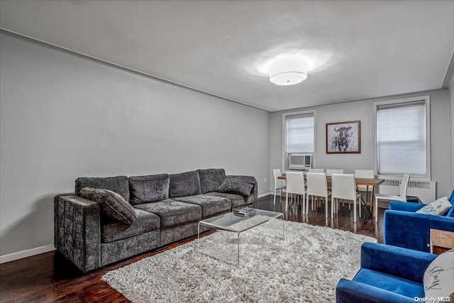 living room with dark hardwood / wood-style floors, a wealth of natural light, and cooling unit