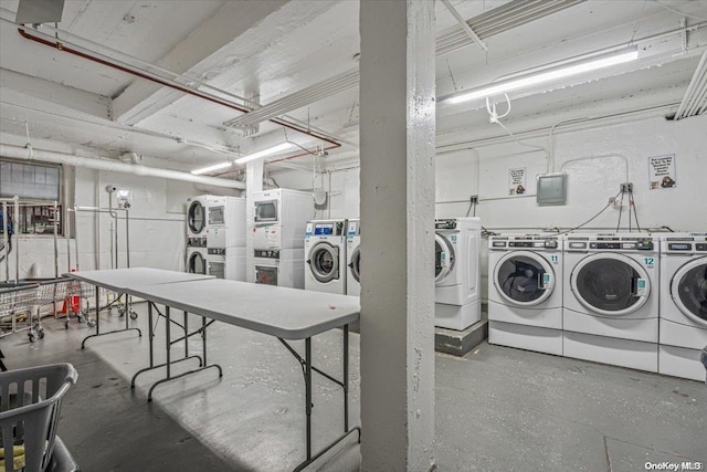 clothes washing area with washing machine and dryer and stacked washing maching and dryer